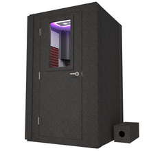 Load image into Gallery viewer, Frontal view of WhisperRoom's Voice Over Basic Package - a 4' x 4' single-wall vocal booth, meticulously designed with acoustic treatment, a functional desk, studio lighting, and a comprehensive range of premium features. The left-hinged door is closed, and the interior is adorned with sophisticated burgundy StudioFoam, creating an ideal recording environment.