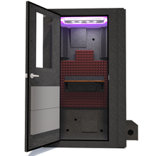 Load image into Gallery viewer, Frontal view of WhisperRoom's Voice Over Basic Package - a 4' x 4' single-wall vocal booth, thoughtfully equipped with acoustic treatment, a functional desk, studio lighting, and a range of premium features. The left-hinged door is open, revealing the interior accentuated with sophisticated burgundy StudioFoam, creating an inviting and professional recording space.