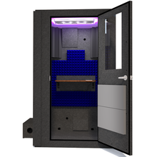 Load image into Gallery viewer, Front view of the WhisperRoom's Voice Over Basic Package - a 4' x 4' single-wall vocal booth, meticulously equipped with acoustic treatment, a functional desk, studio lighting, and an array of premium features. The right-hinged door is open, revealing the vibrant blue StudioFoam interior, creating an ideal recording space.