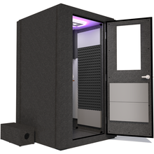 Load image into Gallery viewer, Side view of the WhisperRoom's Voice Over Basic Package - a 4' x 4' single-wall vocal booth, featuring acoustic treatment, a functional desk, studio lighting, and an array of premium features. The right-hinged door is open, revealing the interior accented with sleek gray StudioFoam, creating an ideal recording space.