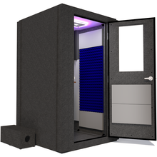 Load image into Gallery viewer, Side view of the WhisperRoom's Voice Over Basic Package - a 4' x 4' single-wall vocal booth, fully equipped with acoustic treatment, a functional desk, studio lighting, and an array of premium features. The right-hinged door is open, revealing the interior adorned with vibrant blue StudioFoam, providing an optimal recording environment.