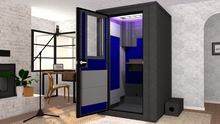 Load image into Gallery viewer, WhisperRoom's Voice Over Deluxe Package: A 4'x4' Double-Wall Vocal Booth equipped with Bass Traps, a Folding Office Desk, Blue Auralex StudioFoam, an Exterior Fan Silencer, Multi-Colored LED Studio Light, and an Acoustic Package, perfectly integrated into a living room home recording studio setup next to a fireplace with a chair at a desk, a laptop, and a complete various other equipment for voiceover.