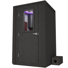 Load image into Gallery viewer, Frontal view of WhisperRoom's Voice Over Deluxe Package - a 4' x 4' double-wall vocal booth, meticulously designed with acoustic treatment, a functional desk, studio lighting, and a comprehensive range of premium features. The left-hinged door is closed, and the interior is enhanced by sophisticated burgundy StudioFoam, creating an ideal recording environment.