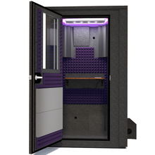 Load image into Gallery viewer, Frontal view of WhisperRoom's Voice Over Deluxe Package - a 4' x 4' double-wall vocal booth, meticulously designed with acoustic treatment, a functional desk, studio lighting, and a comprehensive range of premium features. The left-hinged door is open, revealing the interior enhanced by elegant purple StudioFoam, creating an ideal recording atmosphere.