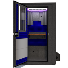 Load image into Gallery viewer, Frontal view of the WhisperRoom's Voice Over Deluxe Package - a 4' x 4' double-wall vocal booth, meticulously designed with acoustic treatment, a functional desk, studio lighting, and a comprehensive range of premium features. The left-hinged door is open, revealing the interior accentuated with vibrant blue StudioFoam, creating an ideal recording atmosphere.