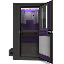 Load image into Gallery viewer, Frontal view of the WhisperRoom's Voice Over Deluxe Package - a 4' x 4' double-wall vocal booth, meticulously designed with acoustic treatment, a functional desk, studio lighting, and a comprehensive range of premium features. The right-hinged door is open, revealing the interior enhanced by elegant purple StudioFoam, creating an ideal recording atmosphere.