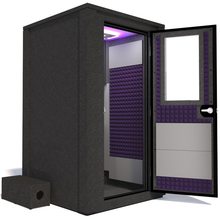 Load image into Gallery viewer, Side view of the WhisperRoom's Voice Over Deluxe Package - a 4' x 4' double-wall vocal booth, thoughtfully equipped with acoustic treatment, a functional desk, studio lighting, and an array of premium features. The right-hinged door is open, revealing the interior enhanced by elegant purple StudioFoam, creating an ideal recording atmosphere.
