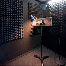 Load image into Gallery viewer, Three Gray Auralex Pyramid StudioFoam Sheets (2' x 4' x 2") Installed in a WhisperRoom with Microphone and Headphones on a Music Stand - Ideal Acoustic Treatment Setup for Recording and Sound Isolation.