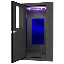Load image into Gallery viewer, A WhisperRoom MDL 4848 S shown from the front with the door open and a studio light inside.