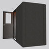 WhisperRoom MDL 4896 S single-wall sound booth shown from a side angle with the door open, revealing the door swing and warm overhead lighting.