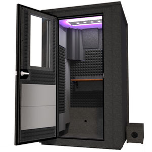 Angled view of the WhisperRoom's Voice Over Deluxe Package - a 4' x 4' double-wall vocal booth, thoughtfully equipped with acoustic treatment, a functional desk, studio lighting, and an array of premium features. The left-hinged door is open, revealing the interior enhanced by sophisticated gray StudioFoam, creating an ideal recording atmosphere.