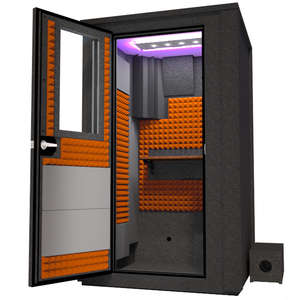 Angled view of the WhisperRoom's Voice Over Deluxe Package - a 4' x 4' double-wall vocal booth, thoughtfully equipped with acoustic treatment, a functional desk, studio lighting, and an array of premium features. The left-hinged door is open, revealing the interior enhanced by vibrant orange StudioFoam, creating an ideal recording atmosphere.
